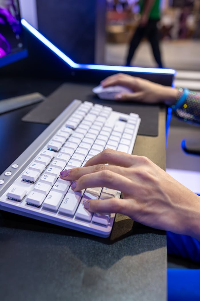 Crafting Captivating Headlines: Your awesome post title goes here Close-up of hands typing on a modern white keyboard at an office desk.