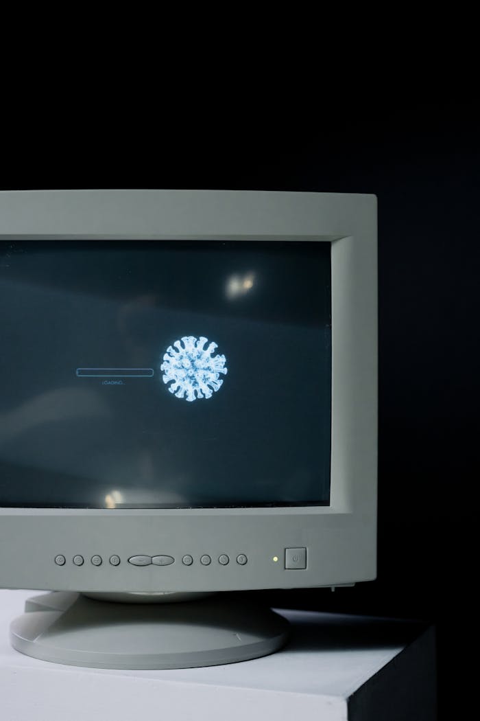 Services Retro computer monitor showing a virus symbol loading on the screen.